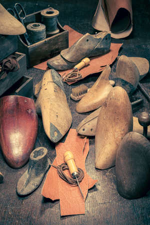 Old cobbler workplace with tools, rules, leather and strap. Old cobbler workplaceの写真素材