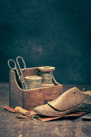 Antique cobbler workplace with tools, strap, leather and rules. Antique cobbler workplace