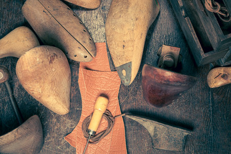 Small shoemaker workshop with tools, laces and shoes. Small shoemaker workshop
