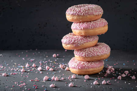 Sweet and homemade pink donuts freshly baked Donuts is most popular takeaway dessert.