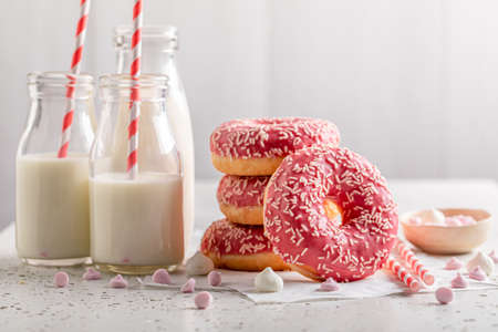 Fresh pink donuts with sprinkles. Served with milk. Donates best taste with milk.