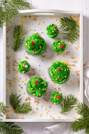 Tasty green cupcakes with flower shaped green cream. Stunning dessert for Christmas.