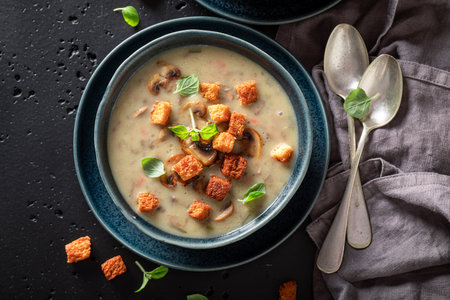 Vegan mushrooms soup with champignons, herbs and cream. Champignons soup made of cream and croutons.の写真素材