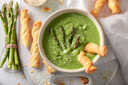 Green creamy asparagus soup as healthy and fresh appetizer. Veggie soup made of vegetables.の写真素材