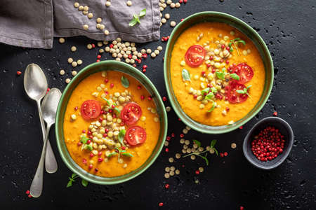 Green lentil soup with cherry tomatoes and cream. Yellow lentil soup made of vegetables.の写真素材