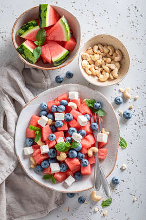 Delicious watermelon salad with blueberries and cashew nuts. Watermelon salad with nuts and berriesの写真素材