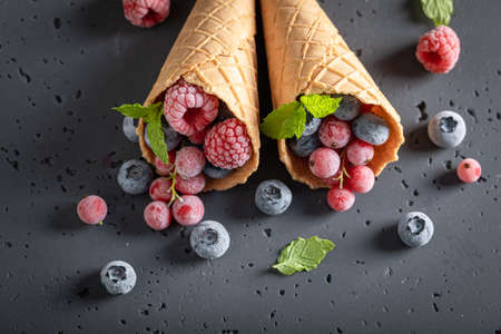 Sweet ice cream as symbol of fruity ice cream. Ice cream in cone made of frozen fruits.