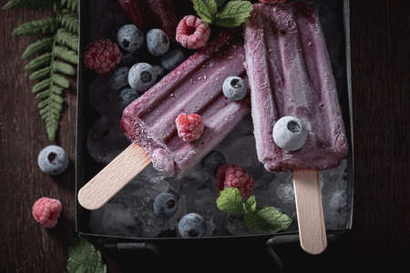 Cold ice cream sorbet flavored with raspberries and blueberries. Cold and sweet ice cream with berries flavor.の写真素材