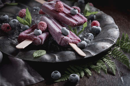 Sweet ice cream sorbet made of frozen berries and mint. Purple sorbet with a berries flavor.