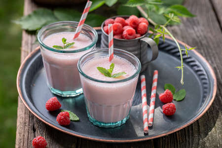 Homemade cocktail as a healthy drink for breakfast. Red smoothie with raspberries and yoghurt.
