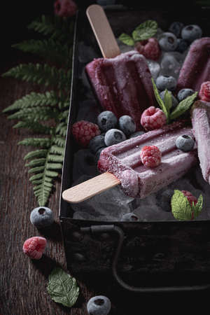 Sweet ice cream sorbet flavored with raspberries and blueberries. Cold and sweet ice cream with...
