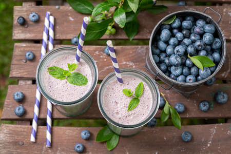 Sweet cocktail flavored with milk and blueberries. Sweet smoothie with berries and yoghurt.の写真素材