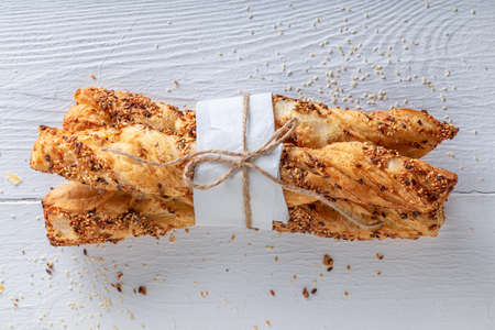 Delicious bread sticks on table in rustic kitchen. Homemade grissini in bakehouse.