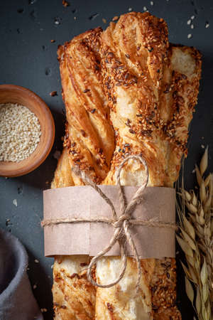 Homemade bread sticks baked in rustic kitchen. Freshly baked grissini with sesame seeds.