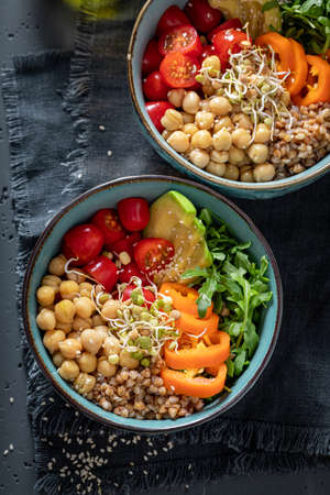 Healthy salad with groats, chickpeas, arugula and vegetables. Nutritious bowl on a diet.