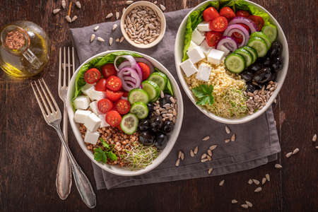 Diet Greek salad with vegetables, cheese and buckwheat groats. Healthy bowls on a diet.の写真素材