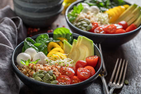 Fit salad with vegetables, olive oil and buckwheat groats. Healthy bowls on a diet.の写真素材