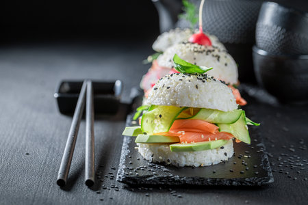 Healthy and tasty sushi burger with seafood and rice as Japanese appetizers. Sushi with seafood made in unique way.の写真素材