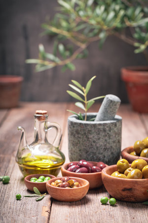 Green and tasty olives with raw olive berries. Products made of olives.の写真素材