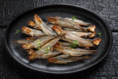 Healthy smoked sprats marinated with spices and salt. Smoked fish marinated with salt and herbs.の写真素材