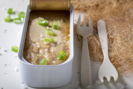 Tasty and healthy herring on a white table with fishing net. Herring in sea salt water.の写真素材