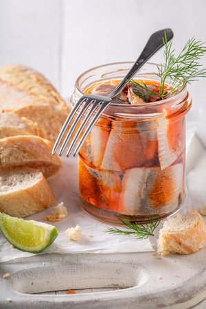 Fresh and delicious pickled herring with tomatoes and onion. Herring in jar served with bread.の写真素材
