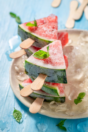 Juicy and sweet watermelon ice cream on cold ice. Frozen watermelon as sorbet ice cream.の写真素材