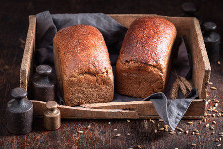 Healthy loaf of breads on wooden board. Bread in the countryside.