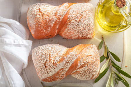 Homemade buns with extra virgin olive oil. Rolls with green olives.