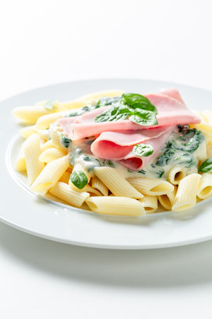 Tasty and homemade pasta with spinach and bechamel sauce. Classic penne bechamel sauce.の写真素材
