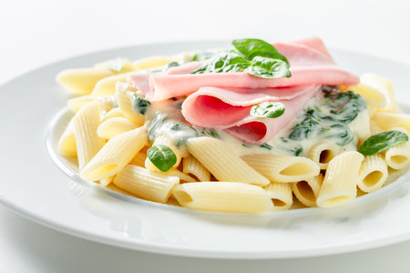 Delicious and fresh penne with ham and bechamel sauce. Most popular pasta with ham.の写真素材