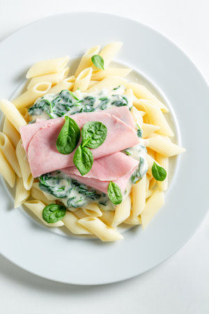 Tasty and homemade penne with ham and bechamel sauce. Most popular pasta with ham.の写真素材