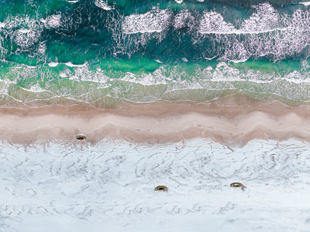 Top down view of fishing boats by Baltic sea on snowy beach in winter in Polandの写真素材