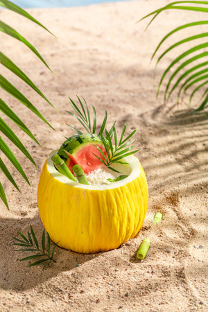 Tasty cocktail in melon on a tropical beach. Drink served on an exotic beach.の写真素材
