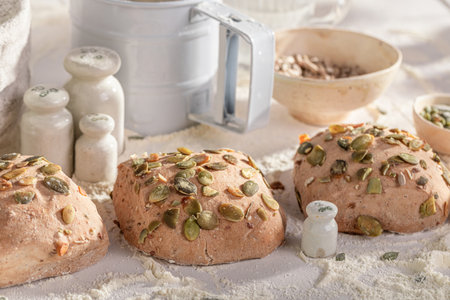 Healthy buns with pumpkin seeds made of flour and sourdough. Rolls baked in a bakery.