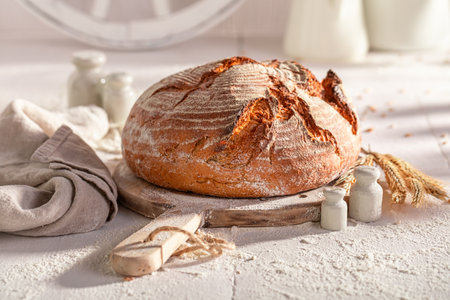 Tasty round loaf bread baked with flour and yeast. Bread in countryside.