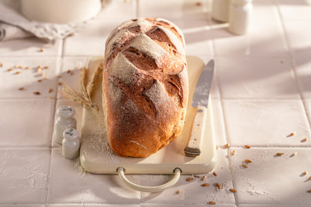 Tin loaf of rye bread baked in a rustic bright kitchen. Homemade bread.