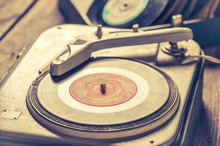 Portable gramophone with few scratched vinyl records. Turntable and some scratched records.の写真素材