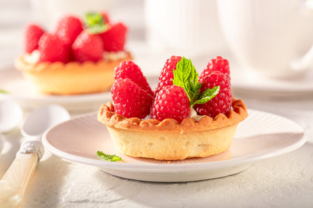 Tasty mini tart made of raspberries and cream. Cake with raspberries and cream.