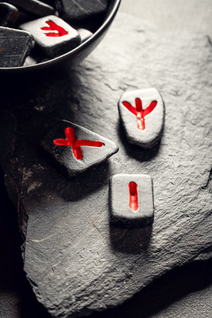 Runic stones with red sign based on futhark alphabet
