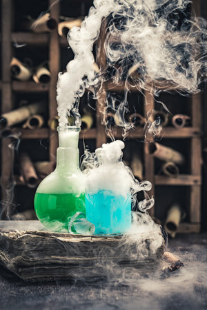 Odd research lab full of ancient scrolls and chemical flask on wooden tableの写真素材