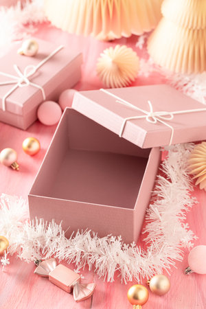 Beautiful Christmas gift box as composition in golden rose color. Cozy wintertime scene.の写真素材