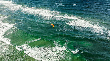 One kitesurfer riding the big waves at sea. Recreation on the Baltic Sea, Tourism in Poland.の写真素材