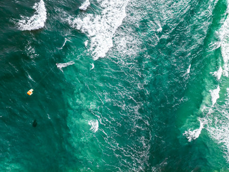 Top down view of kitesurfer riding on big waves at Sea. Recreation on the Baltic Sea, Tourism in Poland.の写真素材