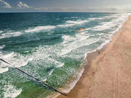 Kitesurfer riding on waves at storm, Baltic Sea, Poland. Recreation on the Baltic Sea, Tourism in Poland.の写真素材