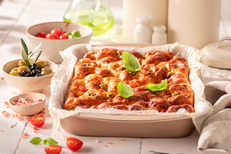 Homemade focaccia baked in a rectangular baking tray. Poster for Restaurant. Focaccia with olives and tomatoes.の写真素材