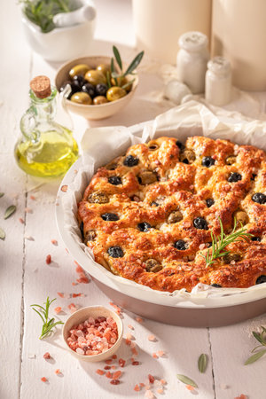 Tasty focaccia made of olives and rosemary. Poster for Restaurant. Focaccia made of simple ingredients.の写真素材