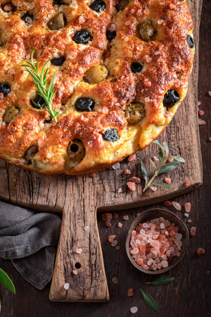Traditional focaccia with olives and olive oil. Classic Italian cuisine. Focaccia with olives.の写真素材