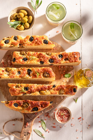 Fresh and traditional focaccia with olives and served with lemonade. Traditional Italian Focaccia.の写真素材