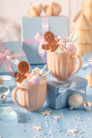 Hot and homemade chocolate as Christmas light blue background. Cozy home atmosphere.の写真素材